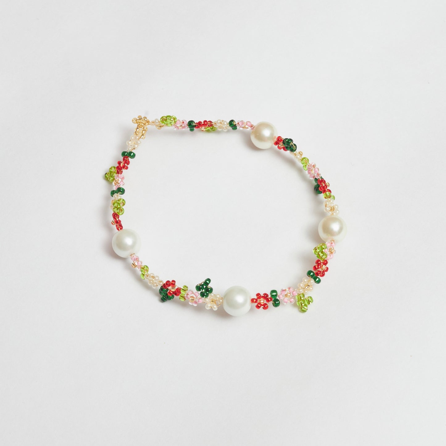 Collar ajustable estilo chocker tejido a mano en mostacilla, muranos y rocaya en forma de flores con colores verde claro, verde oscuro, blanco, rosado, dorado y rojo.